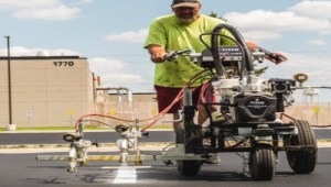 man using line striping machine