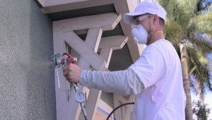 man using paint sprayer